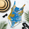 My Store Abstract Harmony one-piece swimsuit in blue, gold, and white. Features a scoop neckline, low scoop back, and cheeky fit.