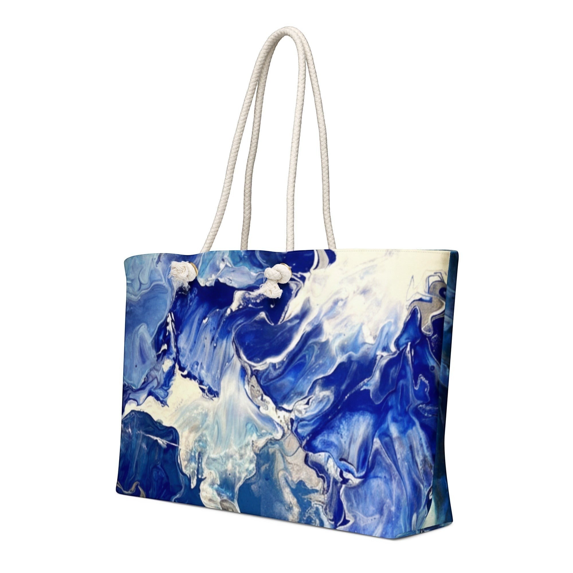 My Store weekender bag with blue and white abstract print, cream rope handles, 100% spun polyester exterior.
Luminous Blue weekender bag with abstract painted pattern and structured shape